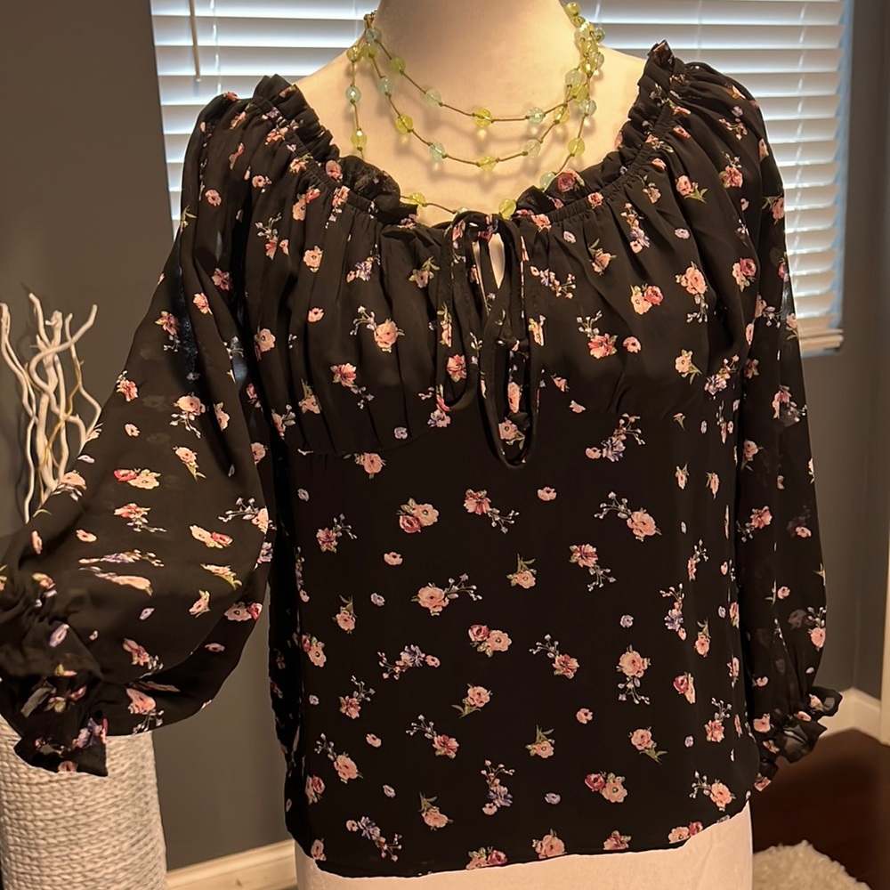 Black floral sheer top with 3/4 sleeves. Tie in front and ruffled sleeve…
